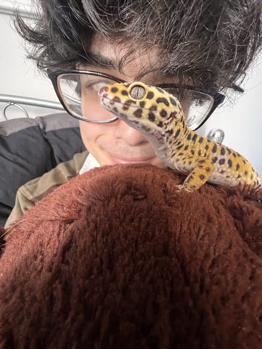 Adam holding Custard the leopard gecko